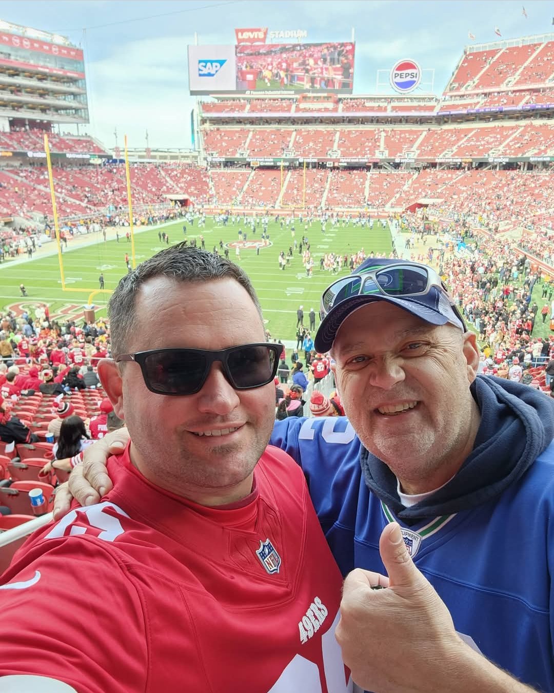 Howard Wheatley smiling at a football game with a friend